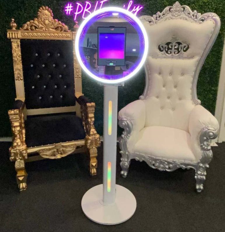 photo booth in front of a decorative throne chair and a plush throne chair 772x1030 2 e1756765170568